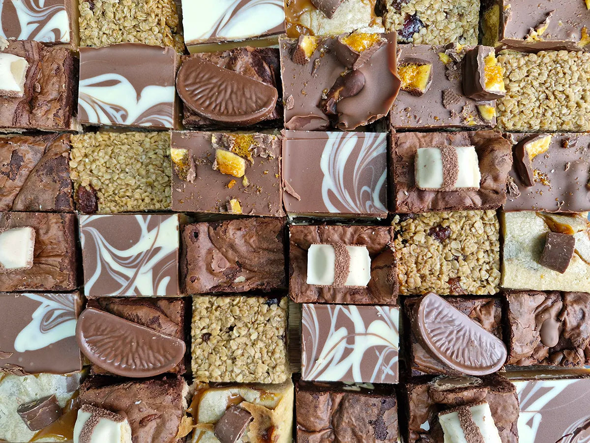 A range of bakes including brownies, blondies, tiffins, flapjacks and millionaires shortbread.