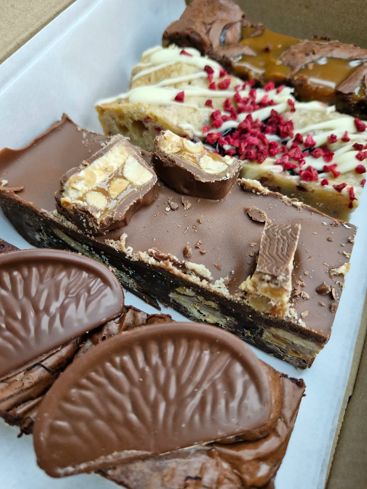 Birthday Selection Box angled view with variety of colourful baked treats visible