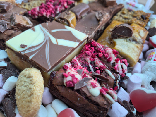 A mix or brownies and blondies with valentine sweets and shortbread - corner view
